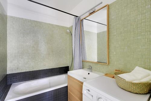 a bathroom with a sink and a mirror at VICTOR HUGO - ARC de TRIOMPHE - TROCADERO in Paris