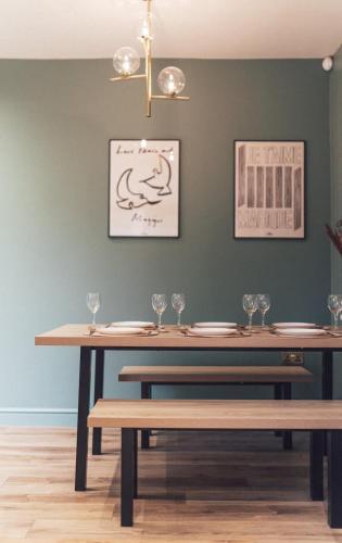a dining room with a table with glasses on it at Regent's Retreat - Stunning home in Middlesbrough in Middlesbrough