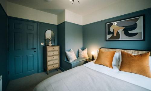 a bedroom with a bed and a dresser and a mirror at Regent's Retreat - Stunning home in Middlesbrough in Middlesbrough