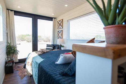 a bedroom with a bed and a large window at New The Buffalo-Shipping Container in Alpine in Alpine