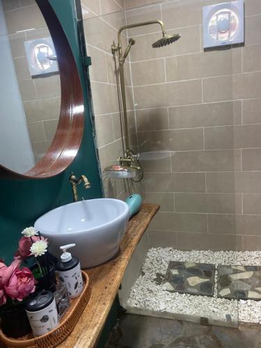 a bathroom with a sink and a shower at Dreamvilles Ecovillage Las Galeras in Las Galeras