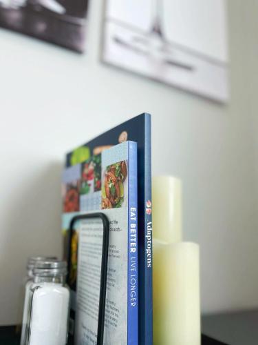 a book sitting on top of a table with candles at *NEW* The Cozy Haven, 5 minutes to ATL airport in Atlanta