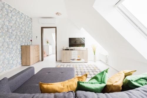 a living room with a couch and a tv at Grand Budapest Penthouse in Budapest