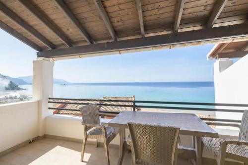 a table and chairs on a balcony with a view of the ocean at Amazing Sea View Balcony Ginos Home 123 in Glyfada