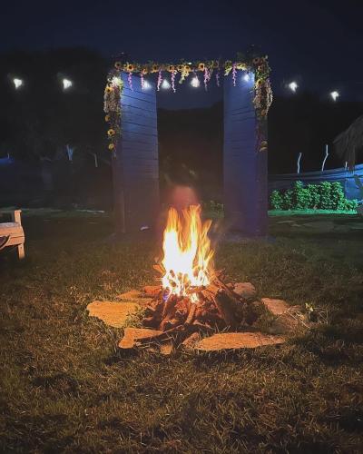 a fire pit in a yard at night at Dreamvilles Ecovillage Las Galeras in Las Galeras