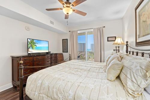 a bedroom with a bed and a flat screen tv at Ariel Dunes II 602 in Destin