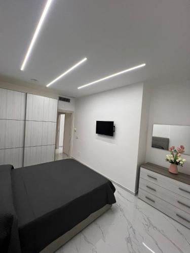 a bedroom with a black bed and a tv at b&b Santa Maria in Santa Maria a Vico