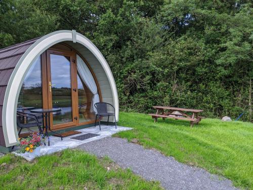 a dome tent with a picnic table and a bench at Killynick Glamping Oiney Fishing County Fermanagh in Enniskillen