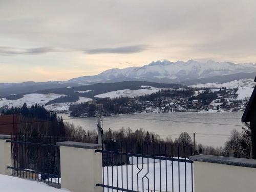 a view of a town and a lake with mountains at Widokowy Zakątek in Czorsztyn