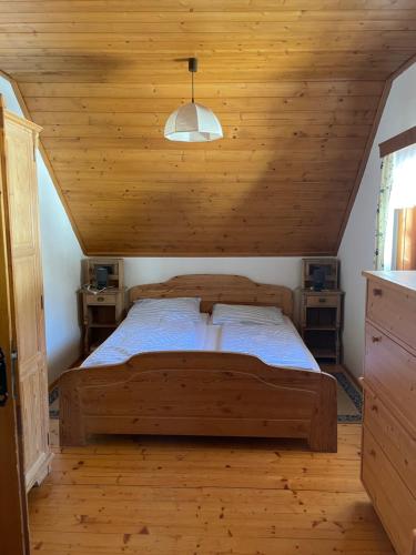 a bed in a room with a wooden ceiling at Ferienhaus Bettina Rassis Feriendorf Donnersbachwald in Donnersbachwald