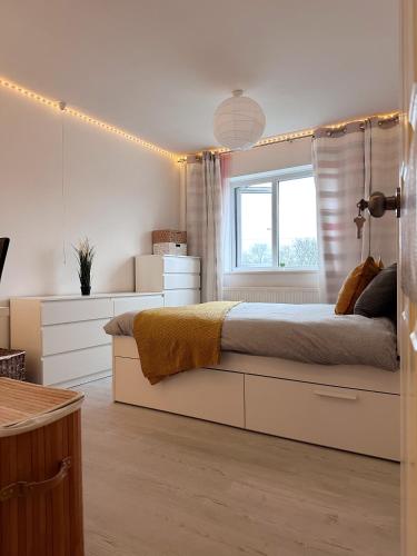 een slaapkamer met een groot bed en een raam bij Come n Go - Homestay in Birmingham