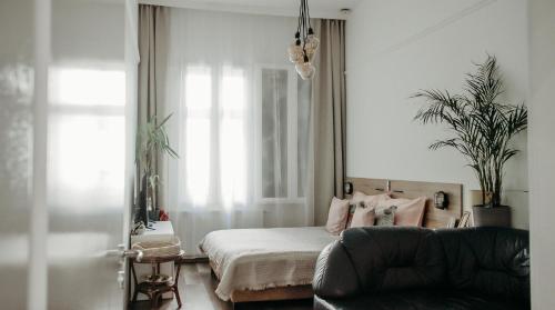 a bedroom with a bed and a couch at The Nest Inn Budapest -Studio with AC in Budapest