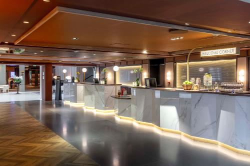 a lobby with a bar in a hotel at Radisson Blu Royal Garden Hotel, Trondheim in Trondheim
