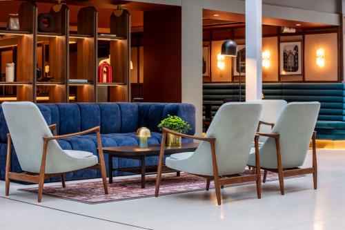 a lobby with a blue couch and chairs and a table at Radisson Blu Royal Garden Hotel, Trondheim in Trondheim