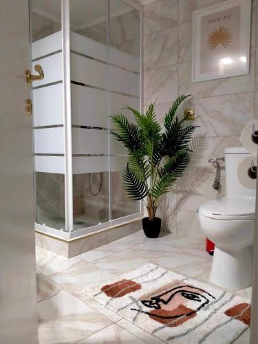a bathroom with a shower and a toilet and a plant at 2BDR Downtown Veria Peach Blossom in Veria