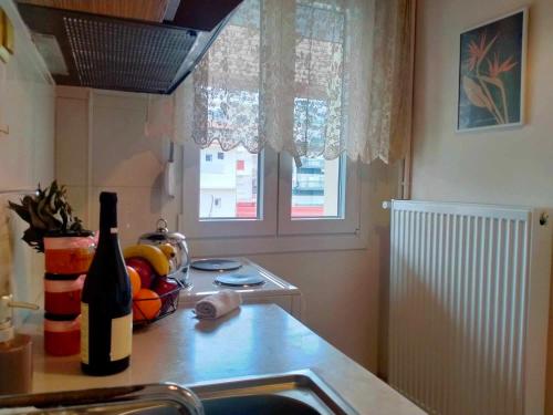 a kitchen with a sink and a bottle of wine at Peach Blossom 2BDR Downtown Veria in Veria
