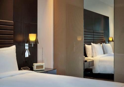 a hotel room with a bed and a tv at art'otel Rome Piazza Sallustio, Powered by Radisson Hotels in Rome