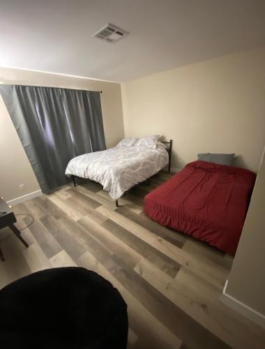 a bedroom with a bed with a red comforter at condo in downtown free parking 4 mins frm Freemont in Las Vegas