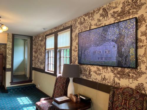 a living room with a tv on the wall at Stone Chalet Bed & Breakfast Inn in Ann Arbor