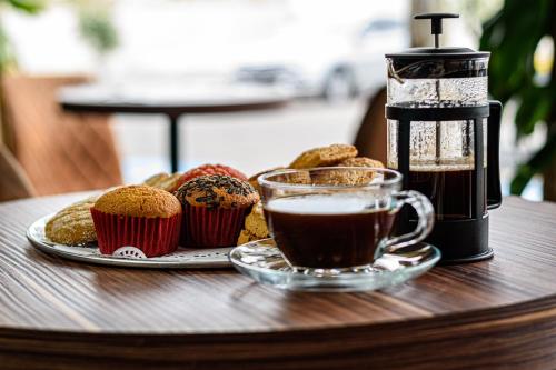 a cup of coffee and muffins on a table at Bedford Hotel in Querétaro