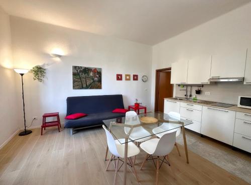 a kitchen and a living room with a table and chairs at La Casa di Leo Apartments in San Giorgio di Piano