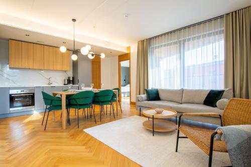 a living room with a couch and a table at Tobiase Residences - Luxury Apartments in Tallinn