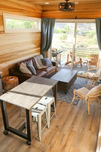 a living room with a table and a couch at Escalante Escapes Star Lily- Bunk Escape in Escalante