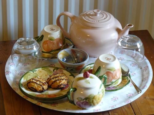a table with a plate of food and a tea pot at Sockbridge Mill Bed and Breakfast in Penrith