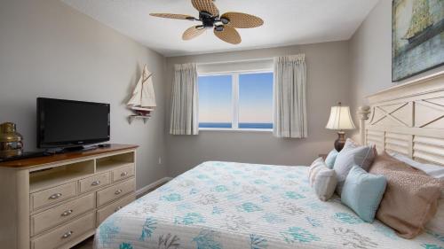 a bedroom with a bed with a television and a window at Westwinds 4848 Su in Destin
