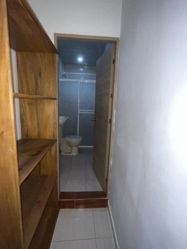 a small bathroom with a toilet and a closet at EL EDÉN in Puerto Triunfo
