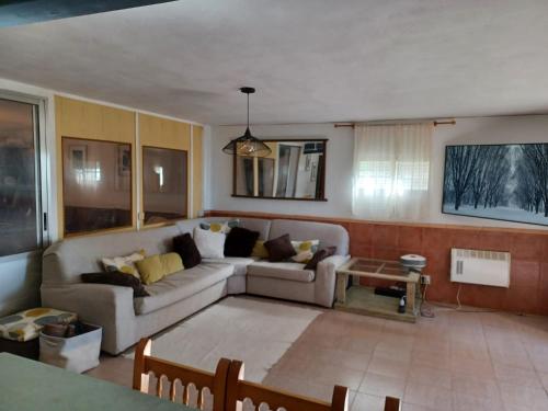 a living room with a couch and a table at Beautiful Villa with huge private pool and vineyard view in Valencia