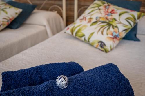 a blue rug with a ring on top of a couch at Elegante Villa Lu' centro Città a 10 minuti dal mare in Cagliari