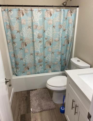a bathroom with a toilet and a shower curtain at Private room. 5 mins from Freemont. 10 mins from strip in Las Vegas