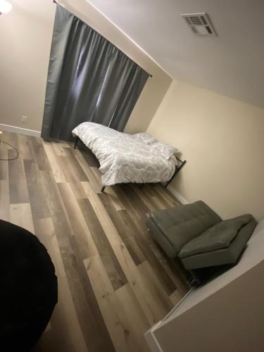 a bedroom with a bed and a couch and a window at Private room. 5 mins from Freemont. 10 mins from strip in Las Vegas