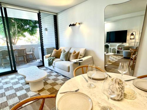 a living room with a table and a couch at Luxury 1 BR Apartment in Randwick- Walk to hospital UNSW Dining W parking and lift and AC in Sydney