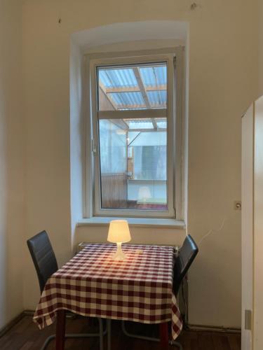 une table avec un chiffon de table et une fenêtre dans l'établissement U6 Schöpfwerk Home 5, à Vienne