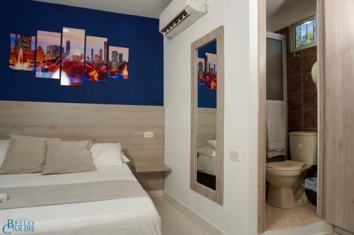 a small bedroom with a bed and a bathroom at Hotel Bello Caribe in Santa Marta