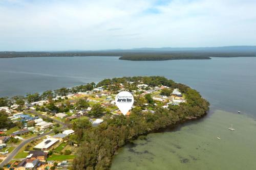 an island in the water with a white circle on it at Aqua by Experience Jervis Bay in Sanctuary Point