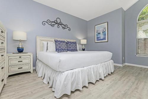 a bedroom with a bed and a dresser and a window at Northshore 960 G in Destin