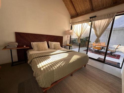 a bedroom with a large bed and a large window at Curiol Boutique Hotel & Lounge in Potrero