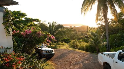 a car parked on a dirt road next to a house at Hotel Sol y Mar in Santa Catalina