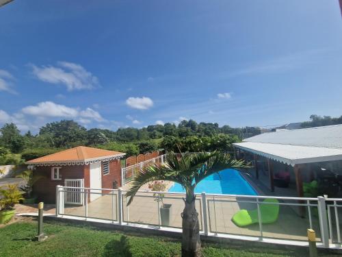 a villa with a swimming pool and a house at Les Villas de Boisvin in Le Moule