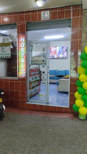 a store front with the door open in a building at Hostal Maria José in Baños