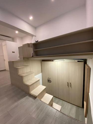a room with a bunk bed and stairs in it at NINA, a centrally located summery studio apartment in Il-Gżira