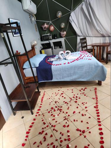 a bedroom with a bed with red hearts on the floor at Cabaña del Lago in Cuatro Esquinas