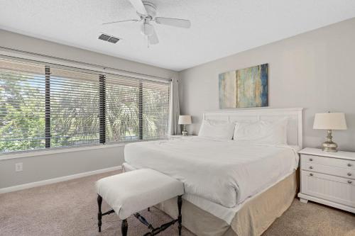 a white bedroom with a bed and a window at Beachwalk Villa 5117 in Destin