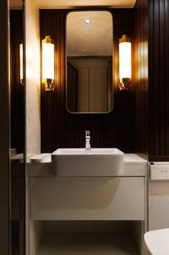 a bathroom with a white sink and a mirror at Wecostay Gangnam in Seoul