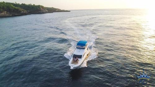 a boat in the water on a lake at Queen Ruizi Private Yacht in Pesanggaran