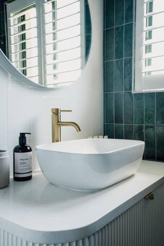 a bathroom with a white sink and a mirror at Sand Road Estate in McLaren Flat