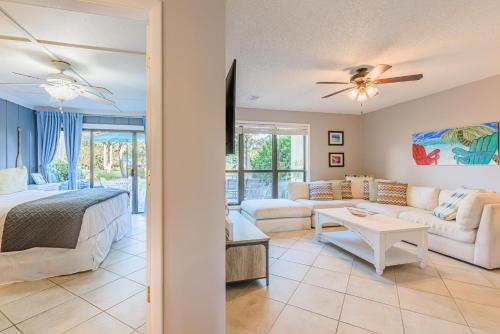 a bedroom and living room with a bed and a couch at Sandpiper Village 715 in Destin